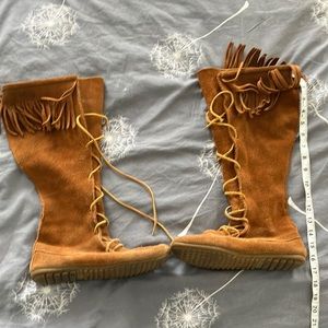 Brown Minnetonka knee-high, fringe, lace up boots boots